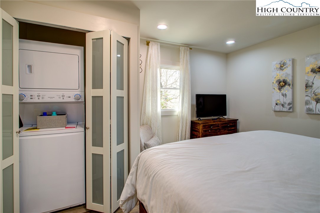 216 Ivy Road Newland, NC 28657 - Photo 10 of 26 a large bedroom with a bed and a flat screen tv
