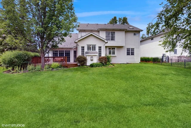 a view of a house with a yard and a potted plant