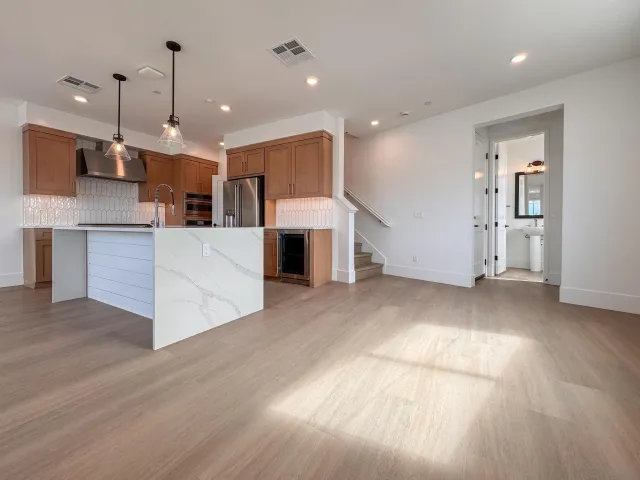 a view of a kitchen with cabinets and wooden floor