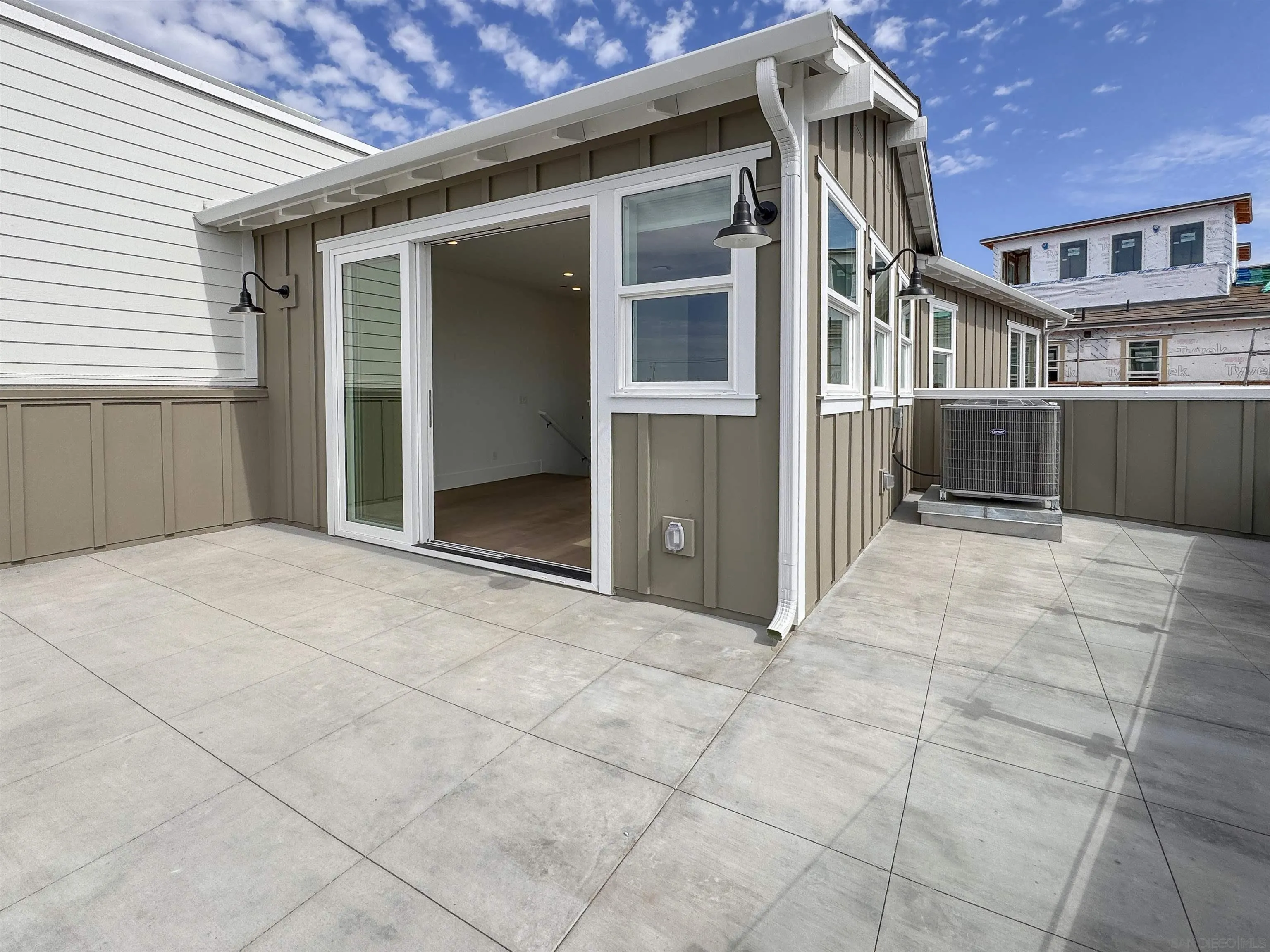 7290 Ponto Drive North, Unit 7302 Carlsbad, CA 92011 - Photo 31 of 55 a view of a house with a wooden fence