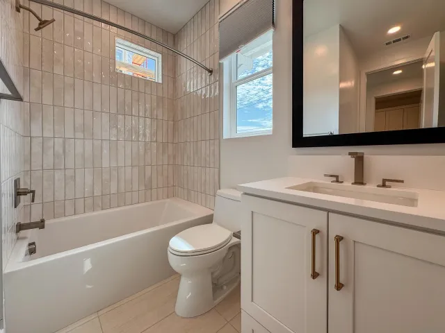 a view of empty room with wooden floor and window