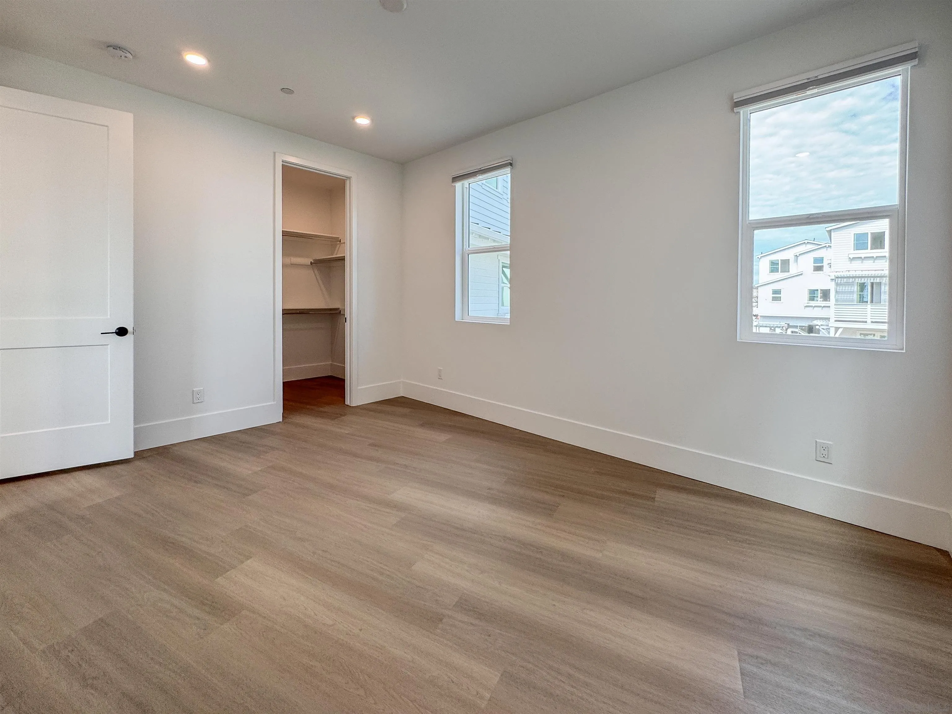 7290 Ponto Drive North, Unit 7302 Carlsbad, CA 92011 - Photo 38 of 55 a view of empty room with wooden floor and window