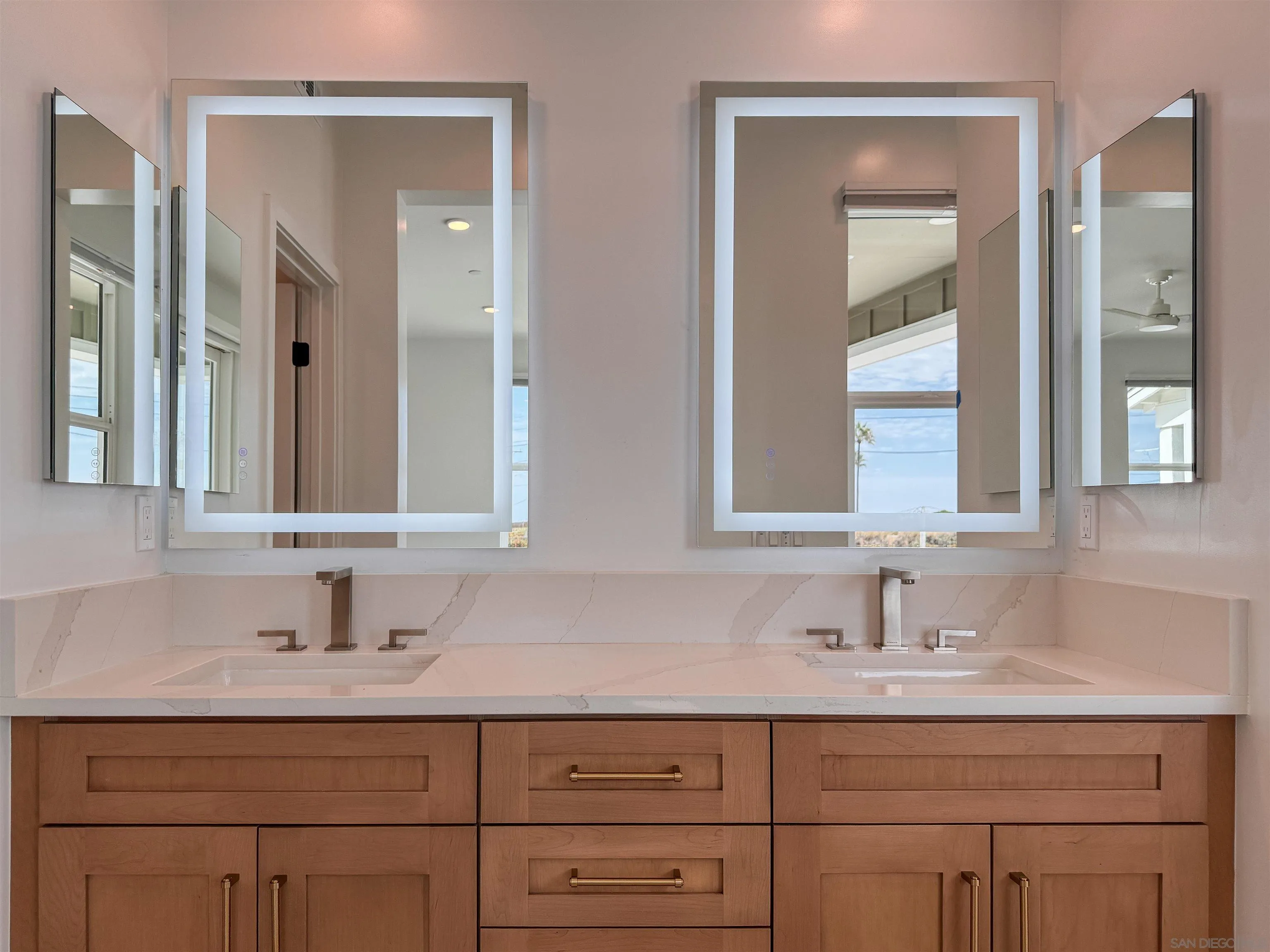 7290 Ponto Drive North, Unit 7302 Carlsbad, CA 92011 - Photo 42 of 55 a bathroom with double sink and a mirror