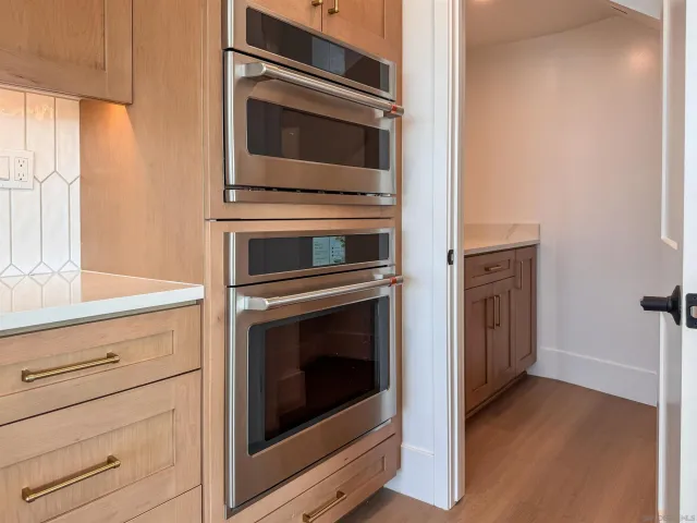 a kitchen with granite countertop cabinets stainless steel appliances and counter space