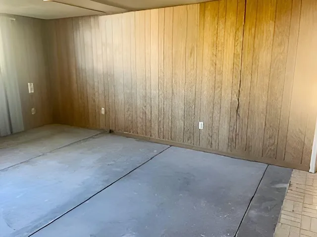 an empty room with a wooden door