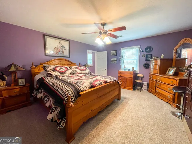 a kitchen with stainless steel appliances granite countertop a stove a sink dishwasher and a refrigerator with wooden floor