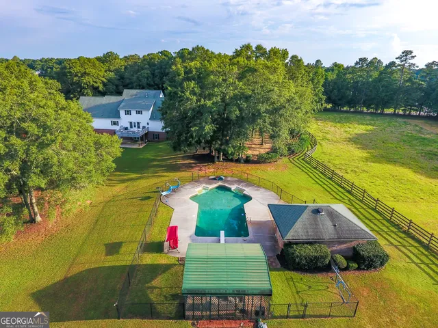 a view of a swimming pool with a yard