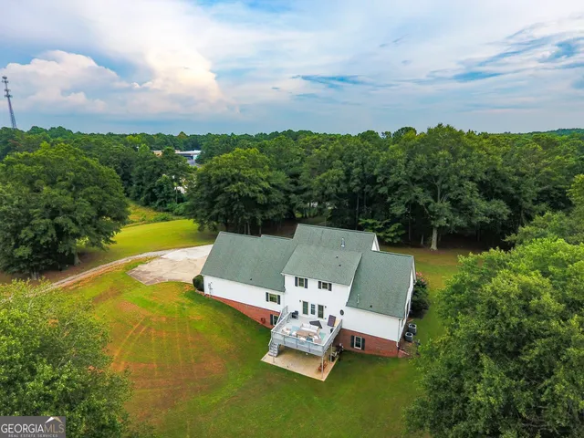 an aerial view of a house with pool patio and outdoor seating