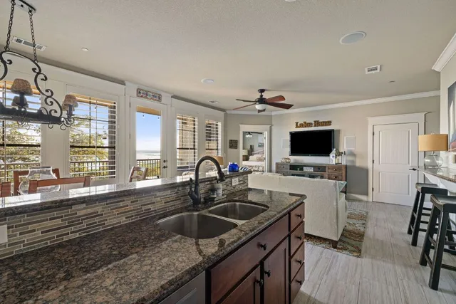 a kitchen with granite countertop a sink and a stove top oven