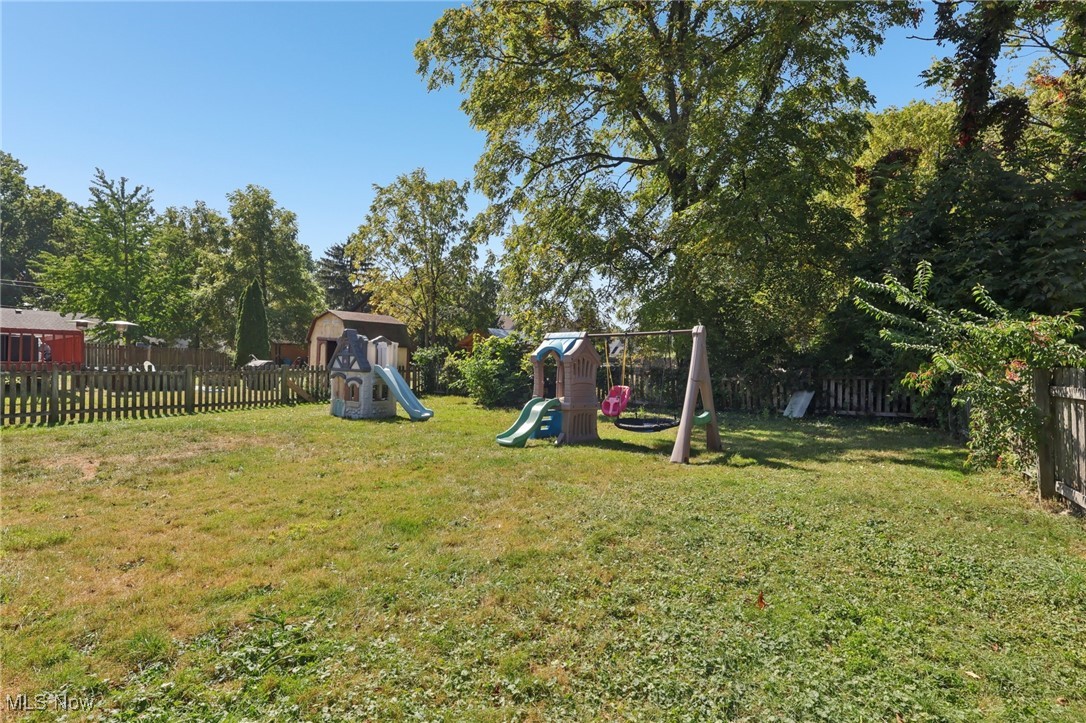 159 Eastland Road Berea, OH 44017 - Photo 36 of 38 Fenced backyard featuring a playground and view of scattered trees