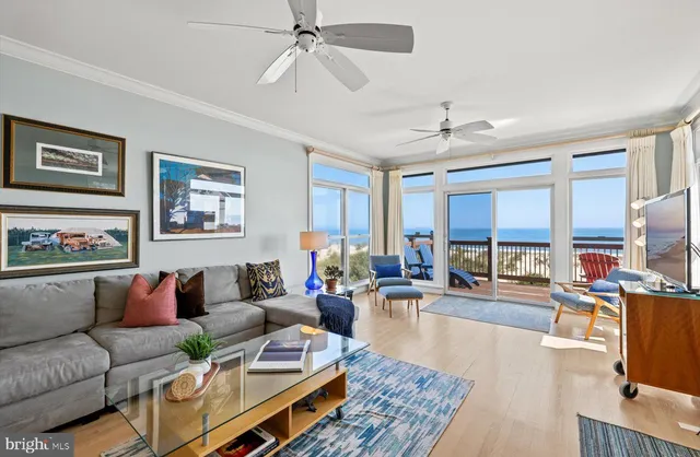 a view of a dining room with furniture a chandelier and wooden floor