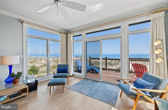 a view of a balcony with furniture and a floor to ceiling window