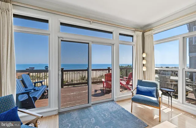 a view of a balcony with wooden floor and outdoor seating