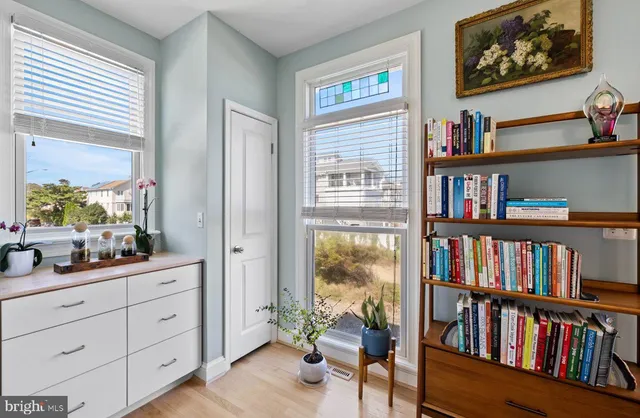 a kitchen with white cabinets and sink
