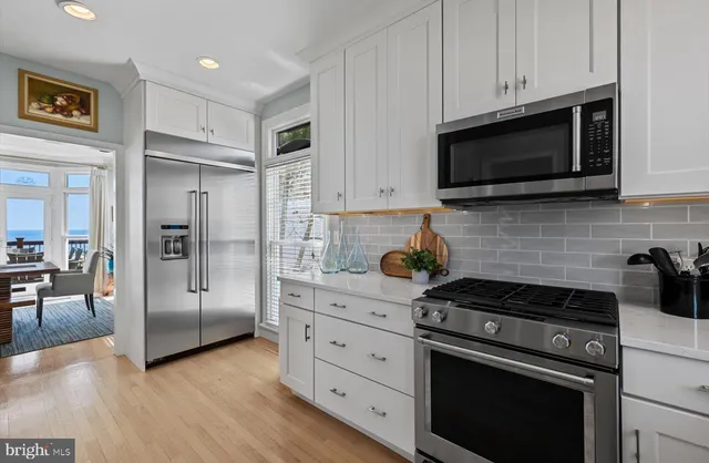 a view of a livingroom with wooden floor and stairs