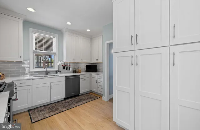 a bedroom with a bed dresser and a window