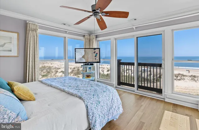 a bathroom with a granite countertop sink toilet and painting on the wall