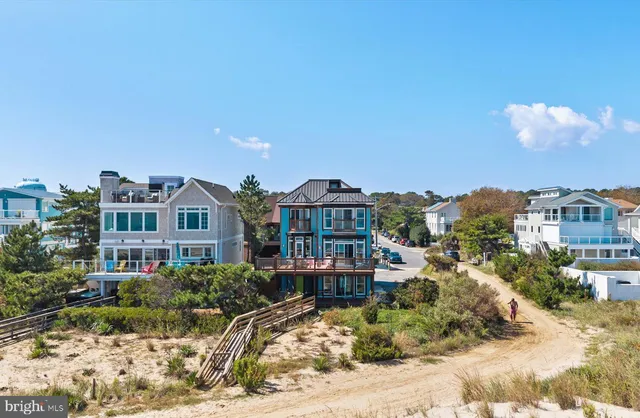 an aerial view of a house with a ocean