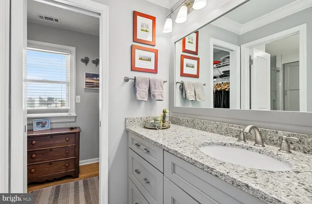 a bathroom with a sink mirror and toilet