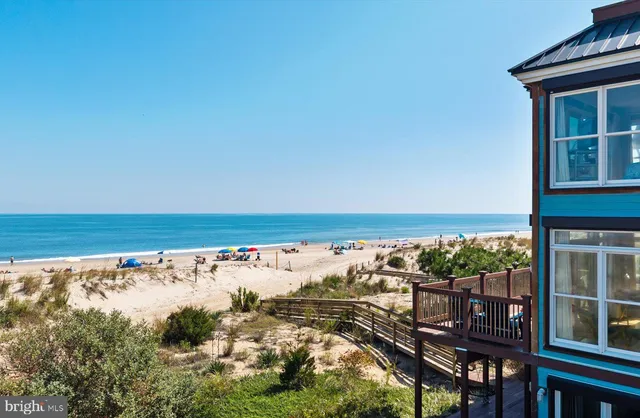 a living room with furniture kitchen view and a large window