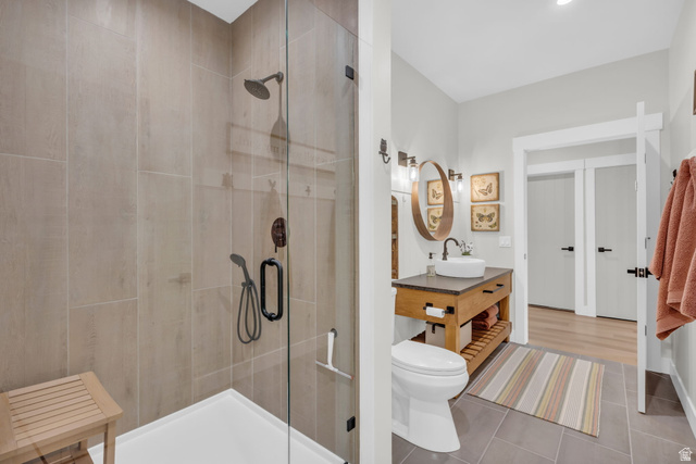 1766 West Tollgate Cyn Road Coalville, UT 84017 - Photo 24 of 59 Walk-in shower with full-height tile surround and dark bronze fixtures, alongside a custom wood vanity with a vessel sink and dark countertop