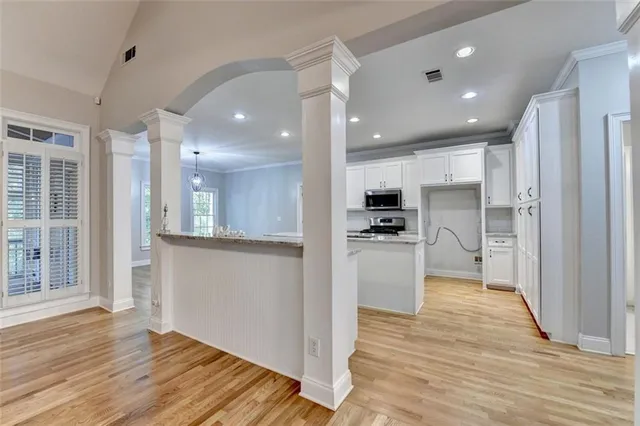 a large kitchen with stainless steel appliances granite countertop a large center island and a stove