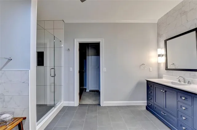 a view of a big room with windows and chandelier fan