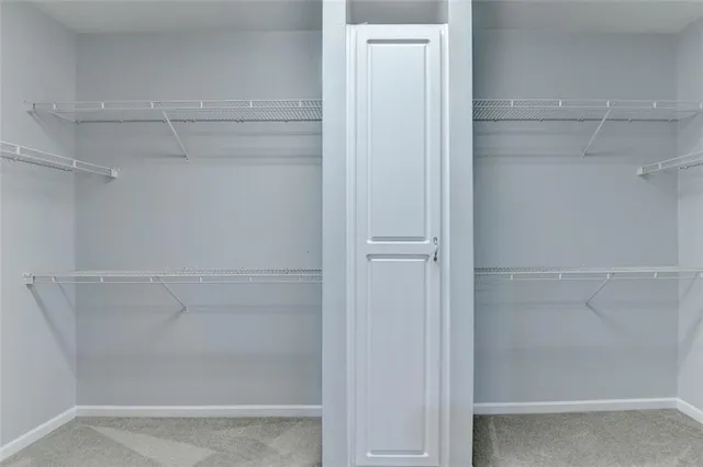 a view of an empty room with a ceiling fan