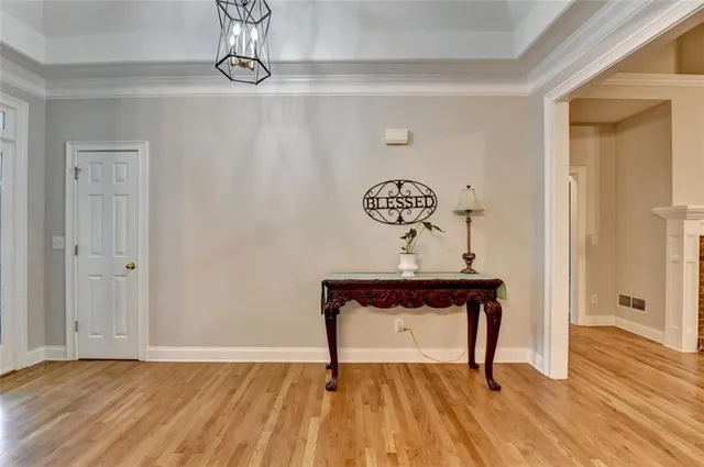 a view of a livingroom with a fireplace wooden floor and a window