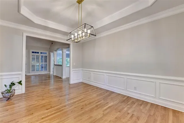 a view of a kitchen with wooden floor and a kitchen space with a sink