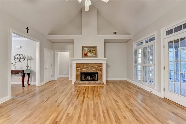 a spacious bathroom with a granite countertop sink a large mirror and shower