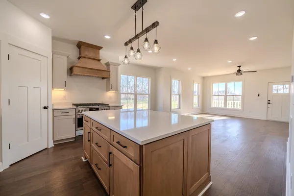 a kitchen with stainless steel appliances granite countertop a sink and stove