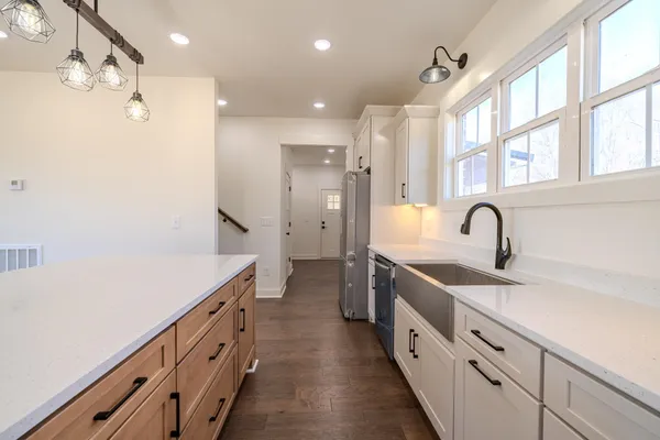 a kitchen with stainless steel appliances granite countertop a sink stove and refrigerator