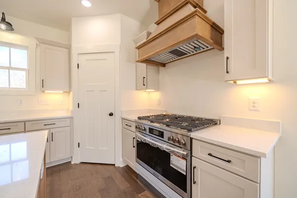a kitchen with granite countertop a stove and a sink