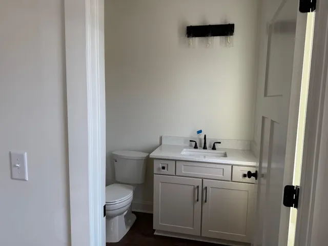 a bathroom with a sink a toilet and a mirror