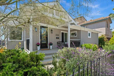 a view of a house with a small yard and plants