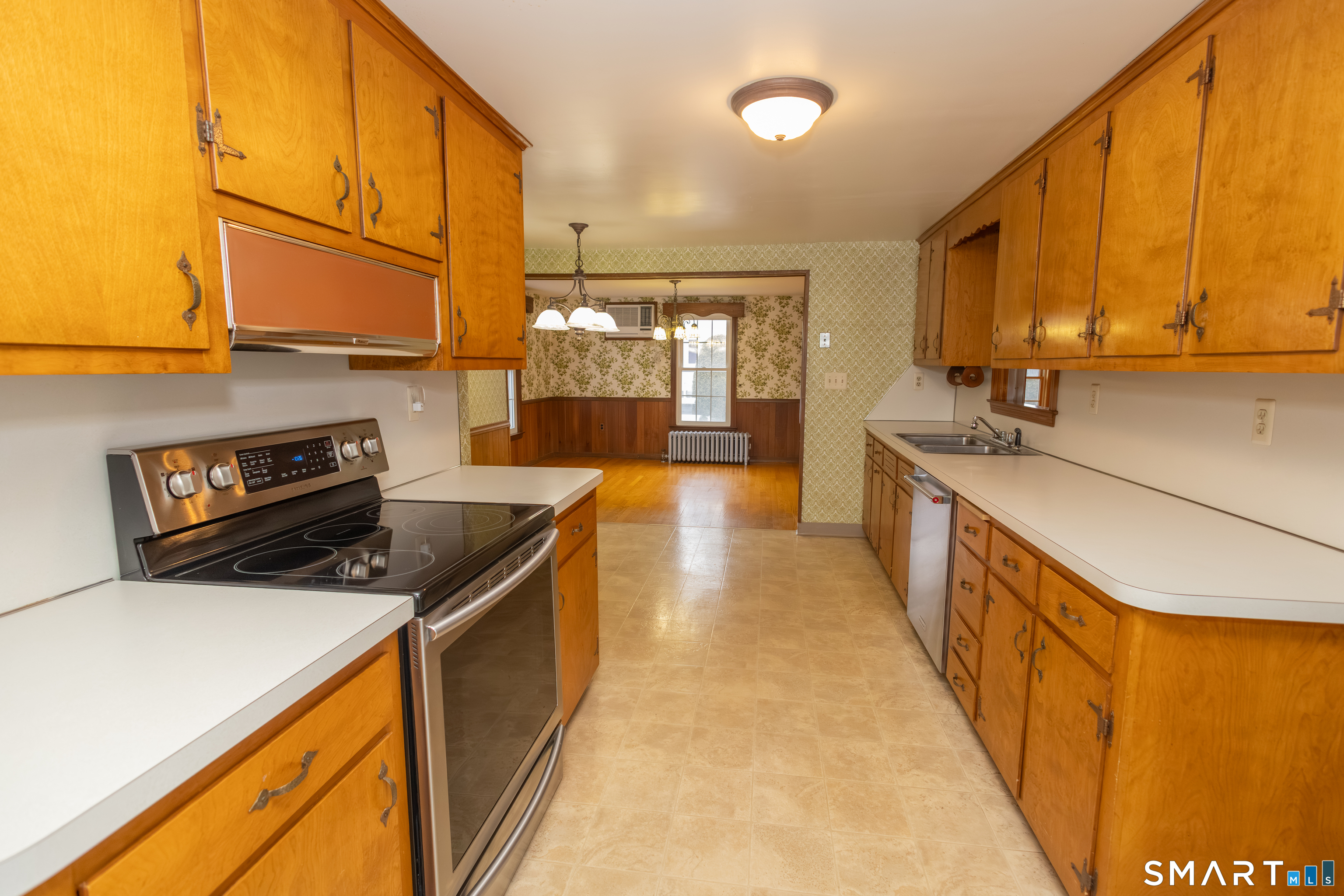 352 Carter Lane Southington, CT 06489 - Photo 19 of 40 a kitchen with stainless steel appliances granite countertop a stove a sink and a refrigerator