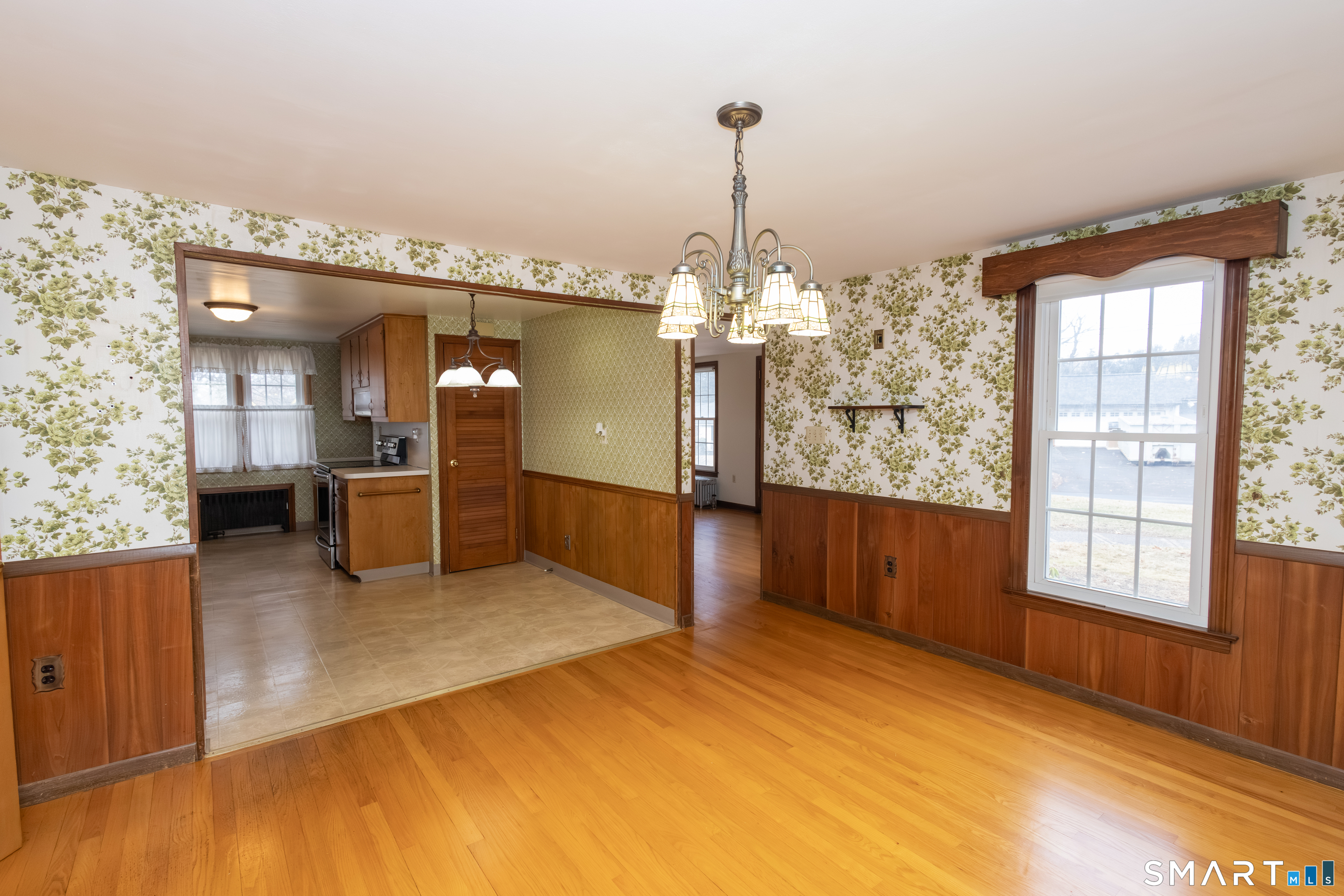 352 Carter Lane Southington, CT 06489 - Photo 22 of 40 a view of a room with window wooden floor and chandelier