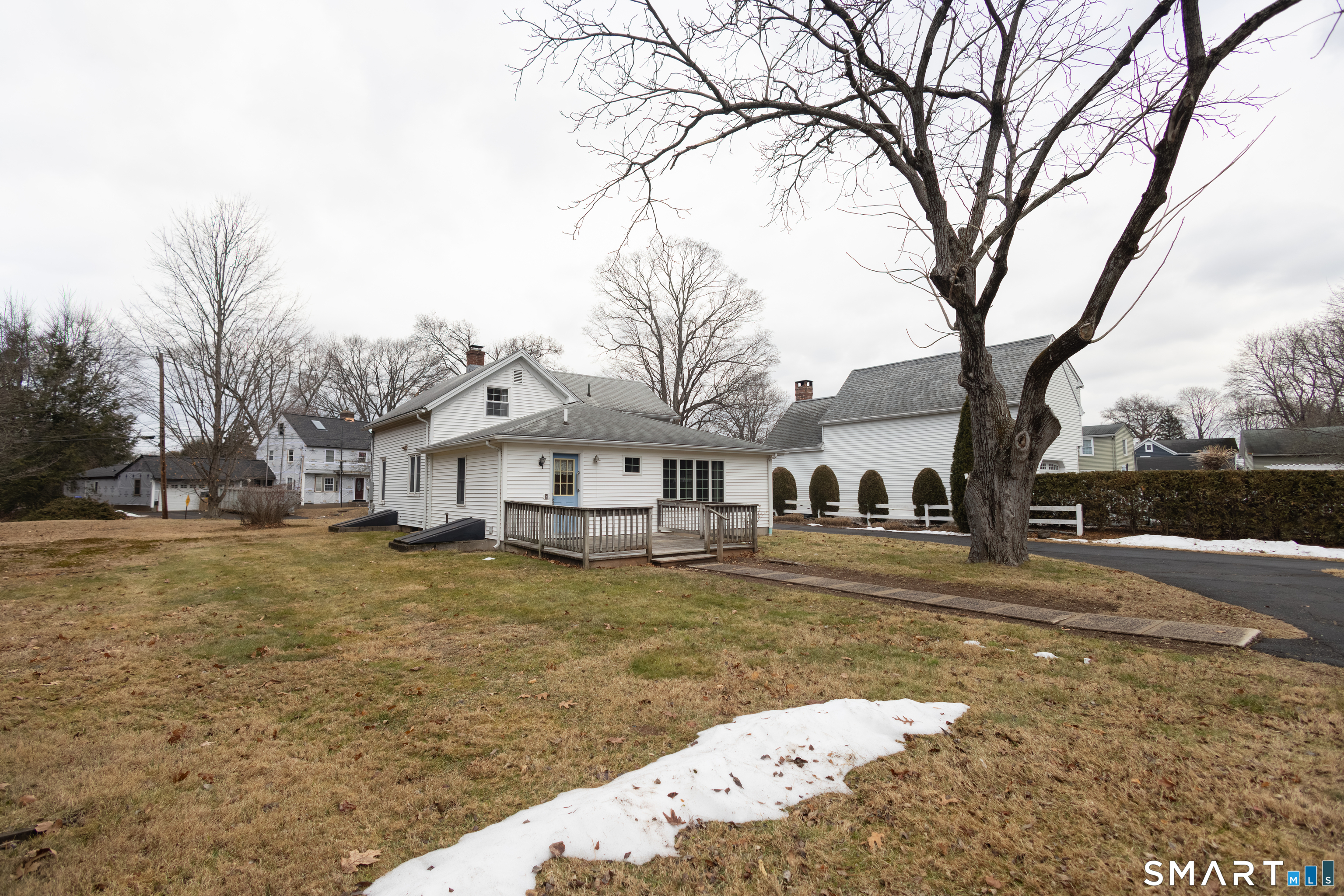 352 Carter Lane Southington, CT 06489 - Photo 4 of 40 a front view of a house with a yard covered with snow and trees