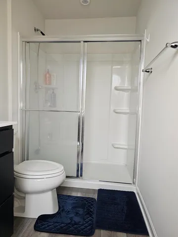 a bathroom with a toilet and a shower