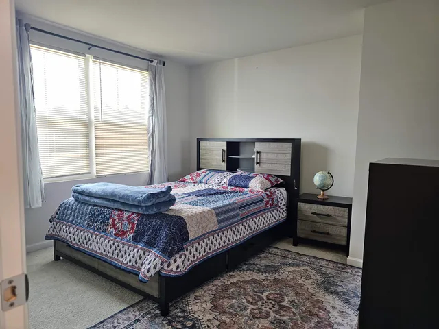 a bedroom with a bed and window