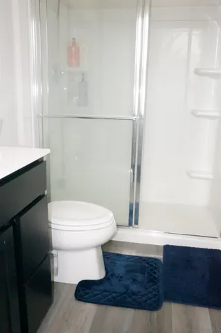 a bathroom with a toilet and a shower