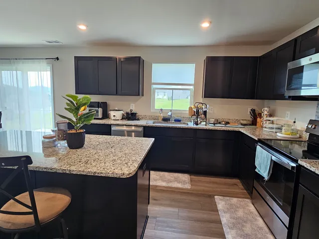 a kitchen with a sink a stove and cabinets