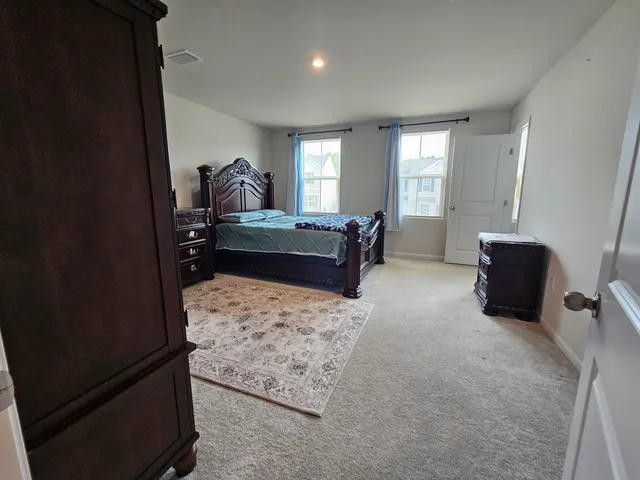 a living room with furniture rug and a flat screen tv