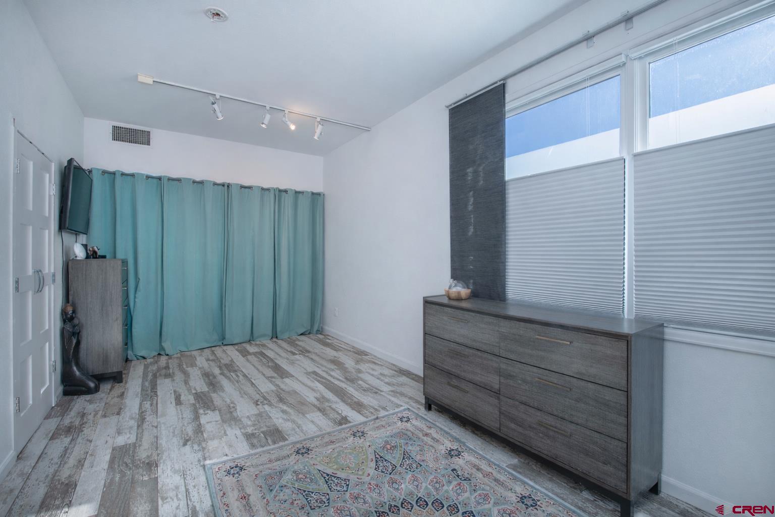 503 Red Lady Avenue, Unit 101 Crested Butte, CO 81224 - Photo 13 of 20 a bedroom with a bed and a mirror