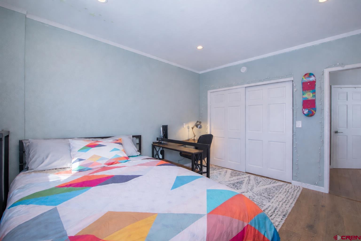 503 Red Lady Avenue, Unit 101 Crested Butte, CO 81224 - Photo 2 of 20 a bedroom with a bed and a table