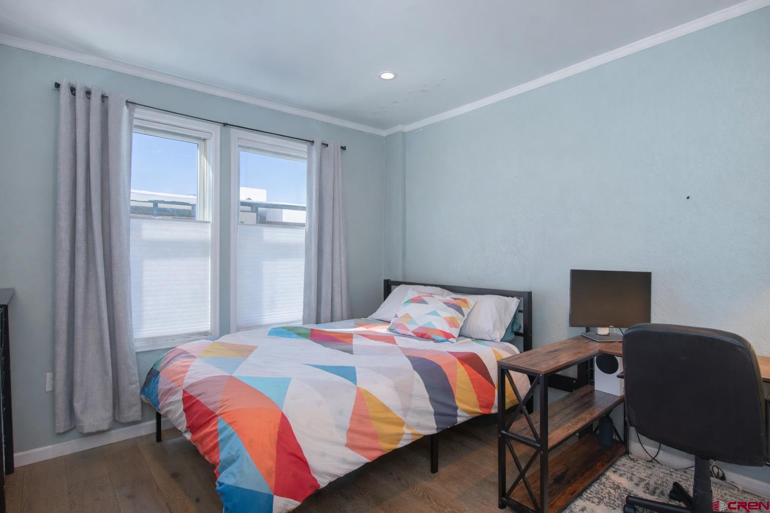 503 Red Lady Avenue, Unit 101 Crested Butte, CO 81224 - Photo 3 of 20 a bedroom with a bed workspace and a window