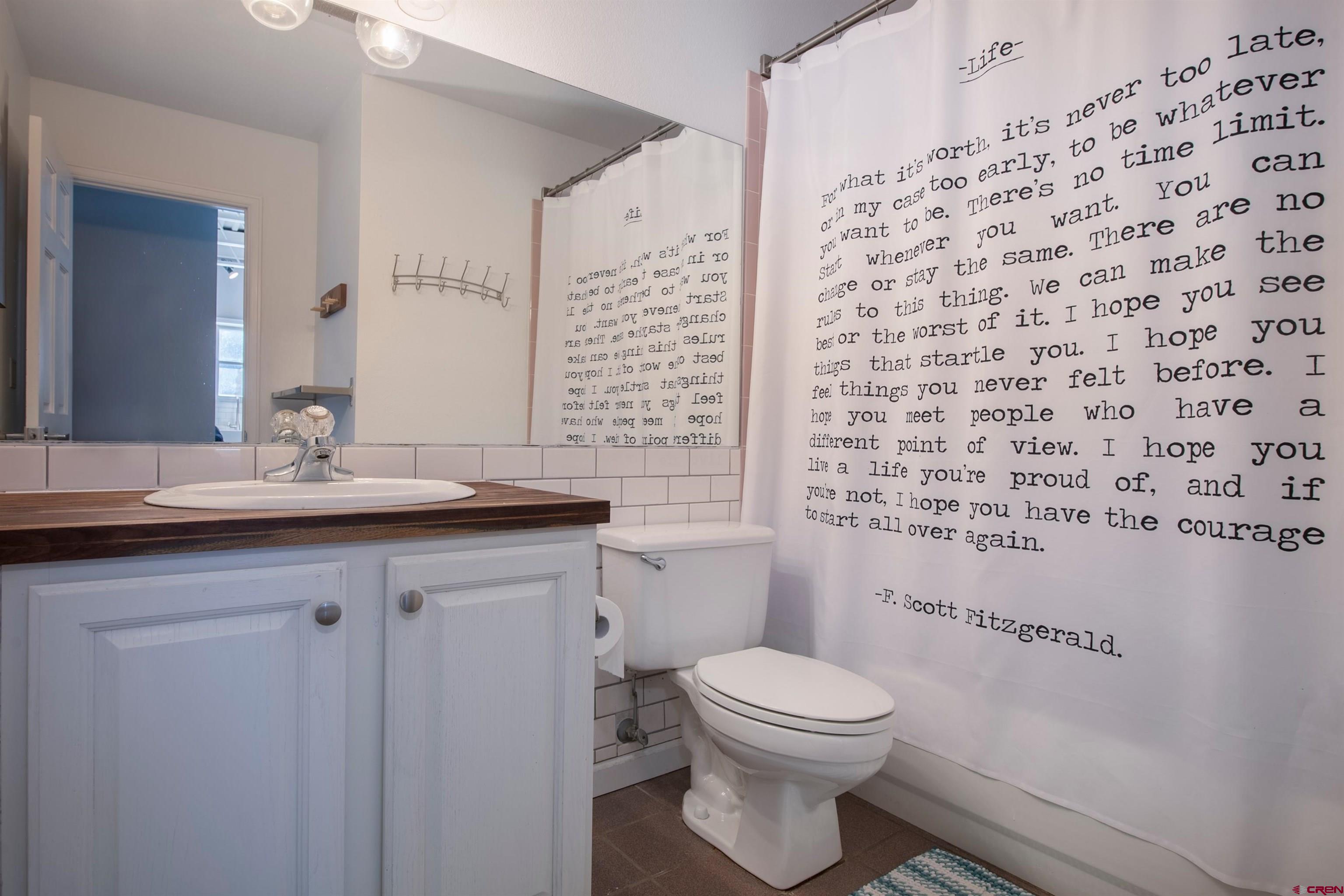 503 Red Lady Avenue, Unit 101 Crested Butte, CO 81224 - Photo 4 of 20 a bathroom with a granite countertop toilet sink and mirror