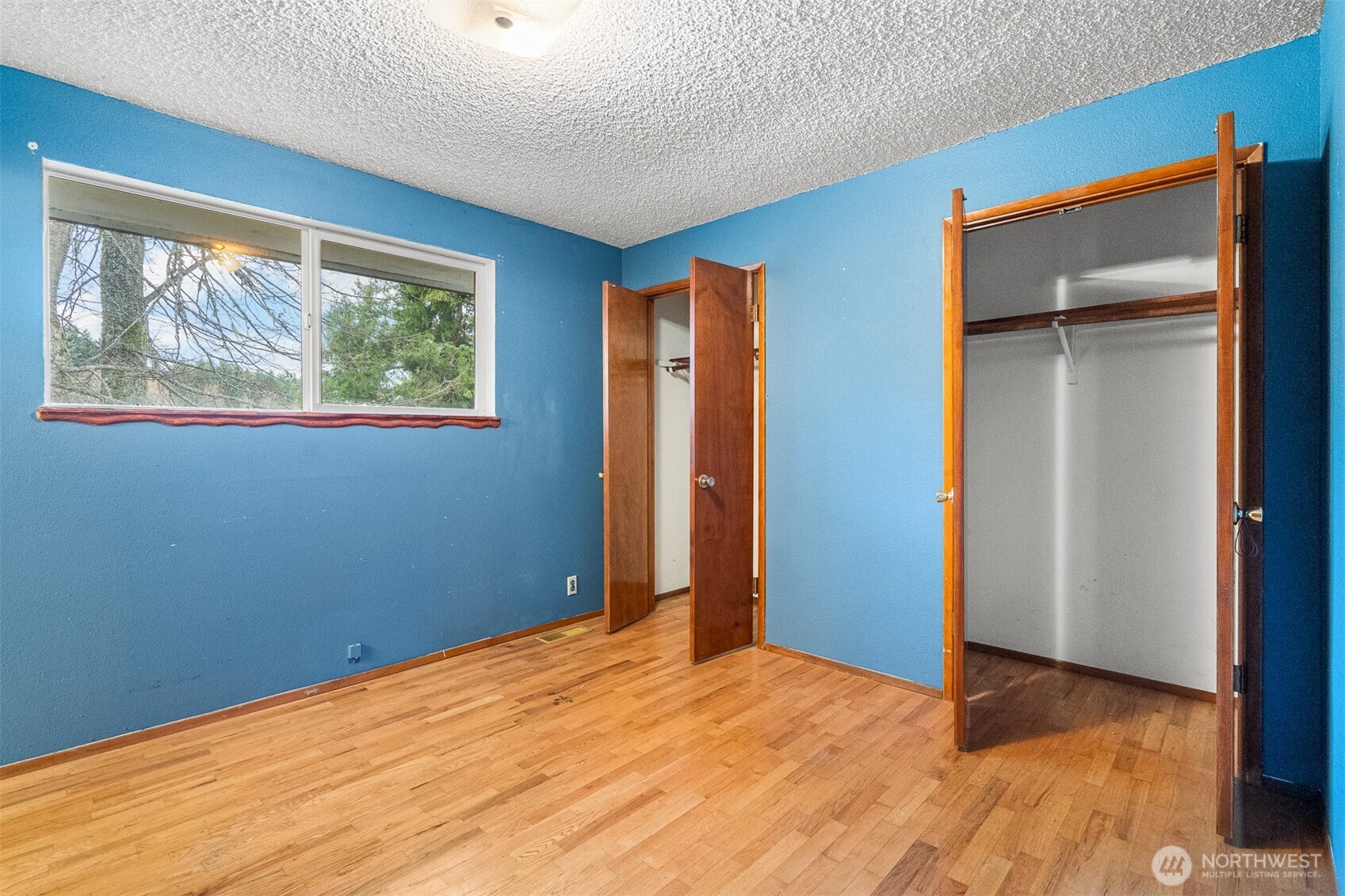 9139 Burnett Road Southeast Yelm, WA 98597 - Photo 16 of 40 a view of empty room with window and wooden floor