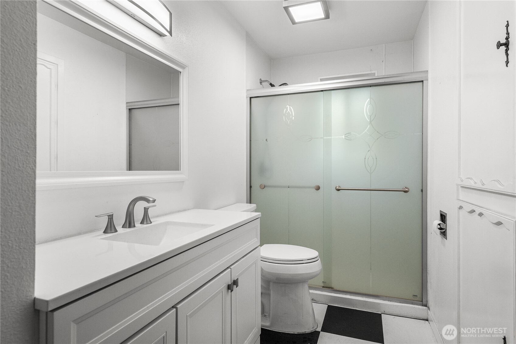 9139 Burnett Road Southeast Yelm, WA 98597 - Photo 19 of 40 a bathroom with a sink a mirror and a toilet
